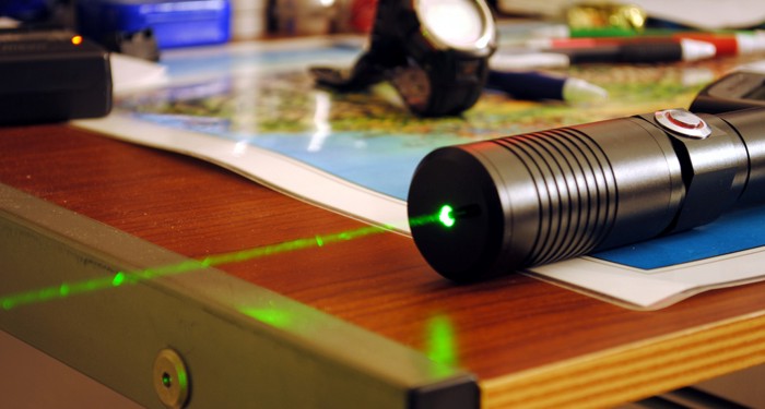 A pocket laser with the beam visible because of dust in the air.